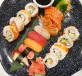 Top view of assorted sushi and soy sauce on dark platter Royalty Free Stock Photo