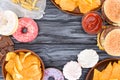 top view of assorted sweets and junk food on wooden table Royalty Free Stock Photo