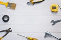 Top view of assorted tools neatly arranged on a white wooden desk, with copy space in the center Royalty Free Stock Photo