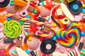 Top view of assortment colourful lollipops and candies on pink like background,  close up Royalty Free Stock Photo