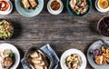 Top view of assortment of food served on a rustic wooden table with copy space