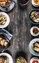 Top view of assortment of food served on a wooden table with copy space