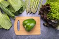 Top View Assortment Of Fresh Organic Vegetables, Green Bell Pepper On Cutting Board On