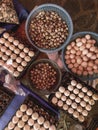 Top view on a assortment of loose eggs on a market, short circuit production