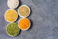 Top view of assortment of peas, lentils, beans and legumes over gray background