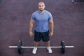 Top view of a athletic man works out at the gym with a barbell