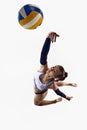 Top view. Athletic, sportive young woman, beach volleyball player in motion, hitting ball in a jump over white Royalty Free Stock Photo