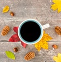Top View of Autumn Leaves and Mug with Coffee on Rustic Wood