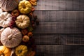 Top view of Autumn maple leaves with Pumpkin and red berries on dark wooden background. Thanksgiving day concept Royalty Free Stock Photo