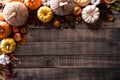 Top view of Autumn maple leaves with Pumpkin and red berries on dark wooden background. Thanksgiving day concept Royalty Free Stock Photo