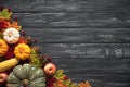 Top view of Autumn maple leaves with Pumpkin and red berries on old wooden backgound. Royalty Free Stock Photo