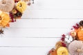 Top view of Autumn maple leaves with Pumpkin and red berries on white wooden background. Thanksgiving day concept Royalty Free Stock Photo