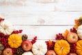 Autumn maple leaves with Pumpkin and red berries on old wooden background. Thanksgiving day concept Royalty Free Stock Photo