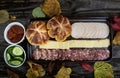 Top view of an autumnal picnic or outdoor meal with pumpkin panini, salami, ham and cheese on a wooden background. Aerial view of