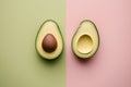top view of avocado halves on pink and green background with copy space