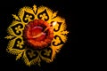 Top view of awesome glowing diya and rangoli on black backgorund with copy sapce. festival of light