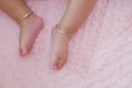 Top view of baby feet place on pink bed sheet with copy space Royalty Free Stock Photo