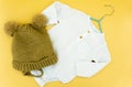 top view of baby suit and baby hat on orange background. winter fashion concept. flat lay flat design. copy space