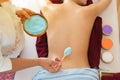 Back plate woman Getting green Salt Scrub Beauty Treatment in the Health Spa. Body Scrub. concept relaxation and health Royalty Free Stock Photo