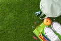 Top view of back to school essentials including backpack, shoes, apple, notebook Royalty Free Stock Photo