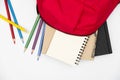 Top view- backpack and school stationery on white background Royalty Free Stock Photo