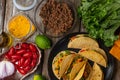 Top view of backstage cooking traditional mexican tacos on rustic wooden background. Tasty street food concept Royalty Free Stock Photo