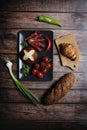 Top view of bacon rolls with fresh vegetables, croissant, and bread on a kitchen table Royalty Free Stock Photo