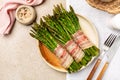 Top view of Bacon Wrapped Asparagus on a beige table Royalty Free Stock Photo