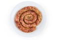 Top view of baked spiral homemade pork sausage on dish Royalty Free Stock Photo