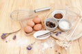 Top View Baking Preparation on wooden Table,Baking ingredients. Bowl, eggs and flour, rolling pin and eggshells on wooden board, Royalty Free Stock Photo