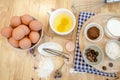 Top View Baking Preparation on wooden Table,Baking ingredients. Bowl, eggs and flour, rolling pin and eggshells on wooden board, Royalty Free Stock Photo