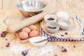 Top View Baking Preparation on wooden Table,Baking ingredients. Bowl, eggs and flour, rolling pin and eggshells on wooden board, Royalty Free Stock Photo