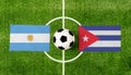 Top view ball with Argentina vs. Cuba flags match on green soccer field