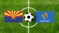 Top view ball with Arizona vs. Oklahoma flags match on green soccer field