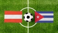 Top view ball with Austria vs. Cuba flags match on green soccer field