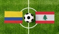 Top view ball with Colombia vs. Lebanon flags match on green football field