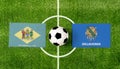 Top view ball with Delaware vs. Oklahoma flags match on green soccer field