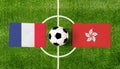 Top view ball with France vs. Hong Kong flags match on green football field Royalty Free Stock Photo