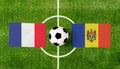 Top view ball with France vs. Moldova flags match on green football field