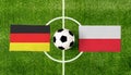 Top view ball with Germany vs. Poland flags match on green soccer field Royalty Free Stock Photo