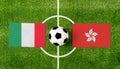 Top view ball with Italy vs. Hong Kong flags match on green football field Royalty Free Stock Photo