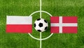 Top view ball with Poland vs. Denmark flags match on green football field