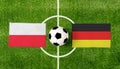 Top view ball with Poland vs. Germany flags match on green football field Royalty Free Stock Photo