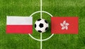 Top view ball with Poland vs. Hong Kong flags match on green football field Royalty Free Stock Photo