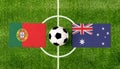Top view ball with Portugal vs. Australia flags match on green football field