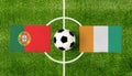 Top view ball with Portugal vs. Cote dIvoire flags match on green football field