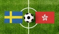 Top view ball with Sweden vs. Hong Kong flags match on green football field Royalty Free Stock Photo