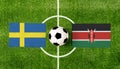 Top view ball with Sweden vs. Kenya flags match on green football field