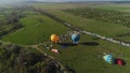 Top view of balloon festival. Shot. Beautiful summer landscape with green fields and balloon festival. Colorful balloons