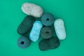 Top view of balls and skeins of yarn in light blue, olive and da Royalty Free Stock Photo